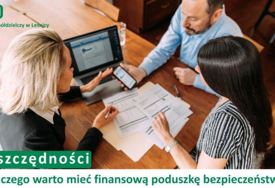 Trzy osoby siedzące przy drewnianym stole – doradczyni bankowa w czarnym żakiecie oraz para klientów. Na stole leżą dokumenty i otwarty laptop, a doradczyni wskazuje coś na ekranie smartfona. W lewym górnym rogu logotyp Banku Spółdzielczego w Leśnicy. Na dole napis: „Oszczędności. Dlaczego warto mieć finansową poduszkę bezpieczeństwa?”